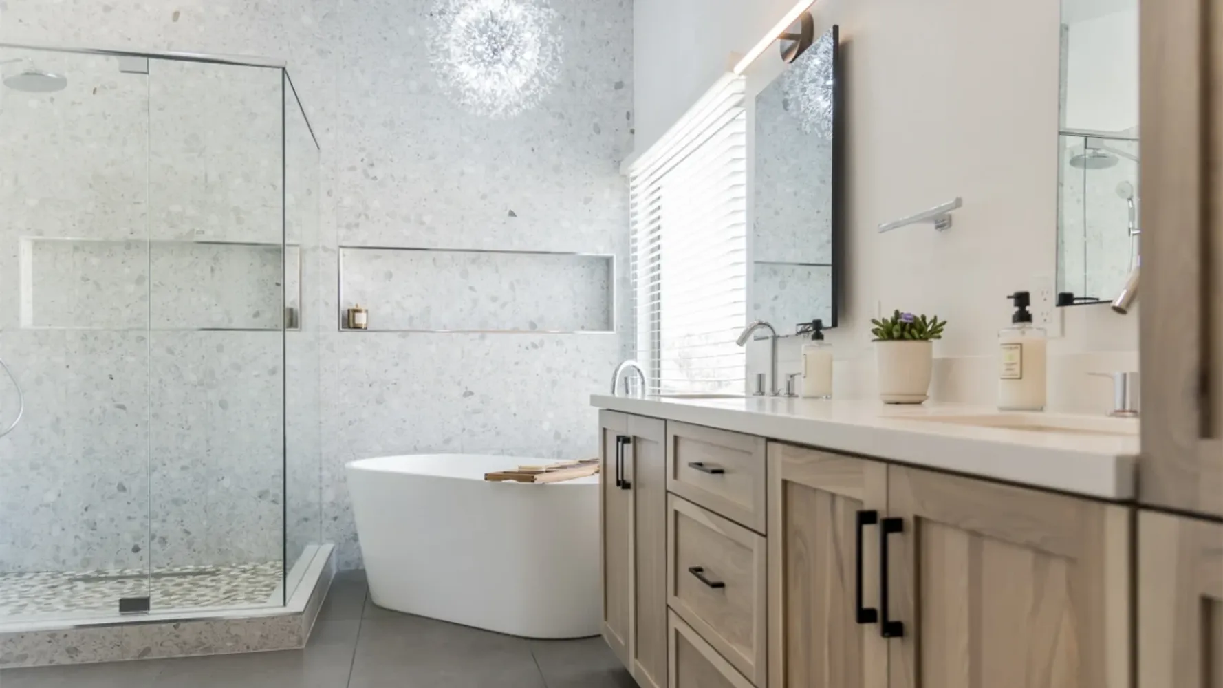 Natural spa-like bathroom with white freestanding tub and floating vanity