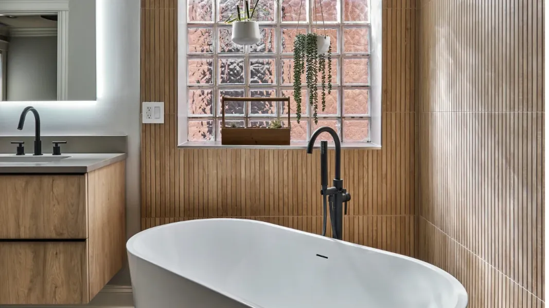 Natural spa-like bathroom with white freestanding tub and floating vanity