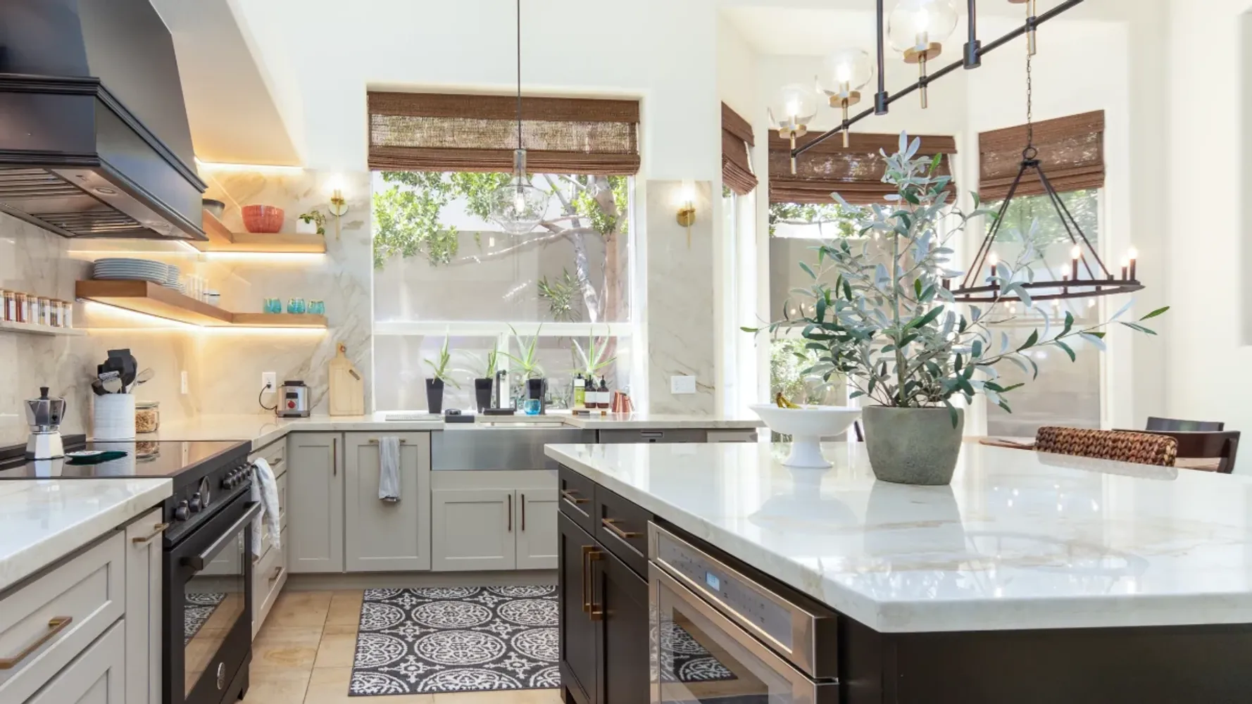 Modern kitchen with white cabinets, large island and black stainless steel fixtures