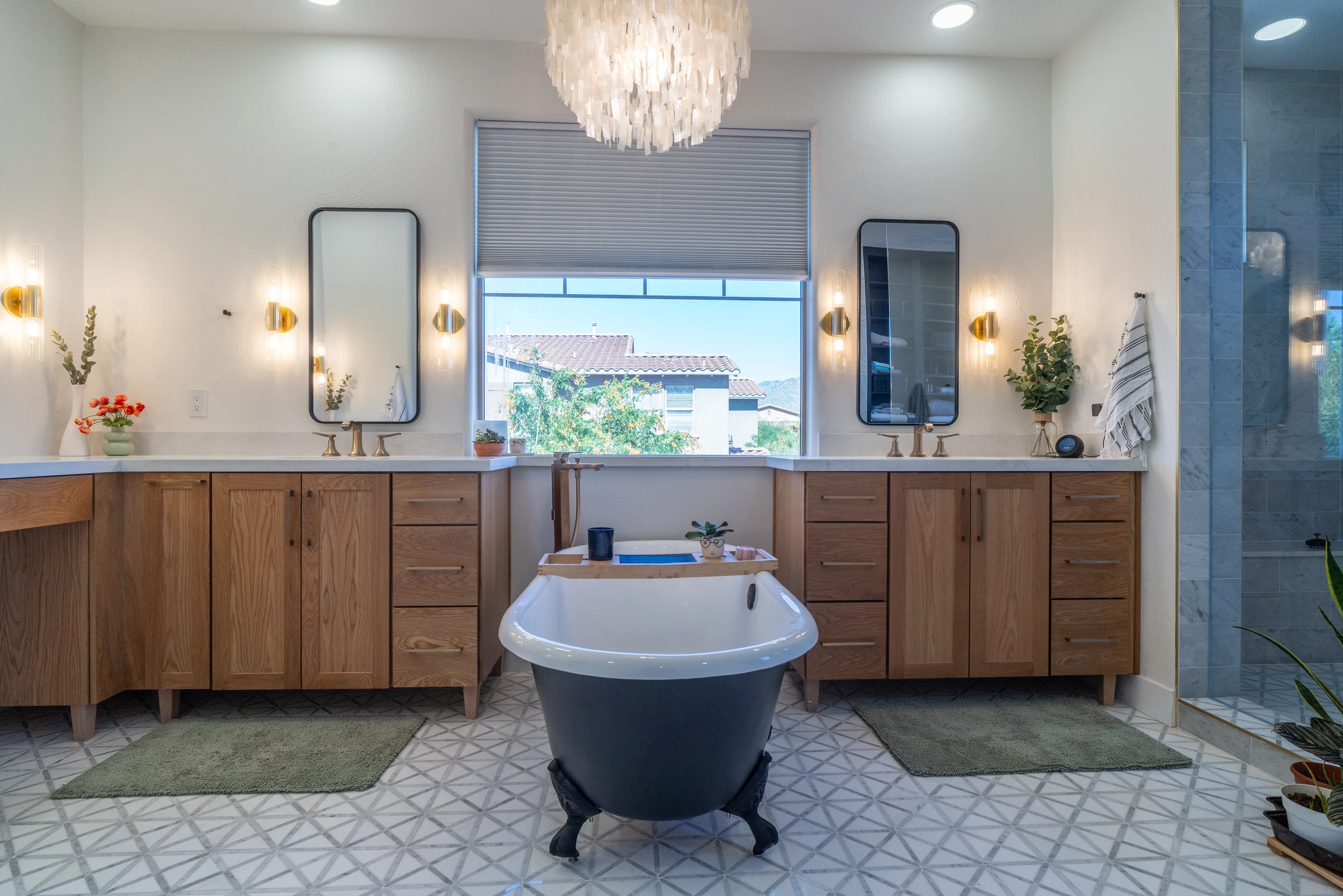 Master bathroom freestanding tub with capiz chandelier