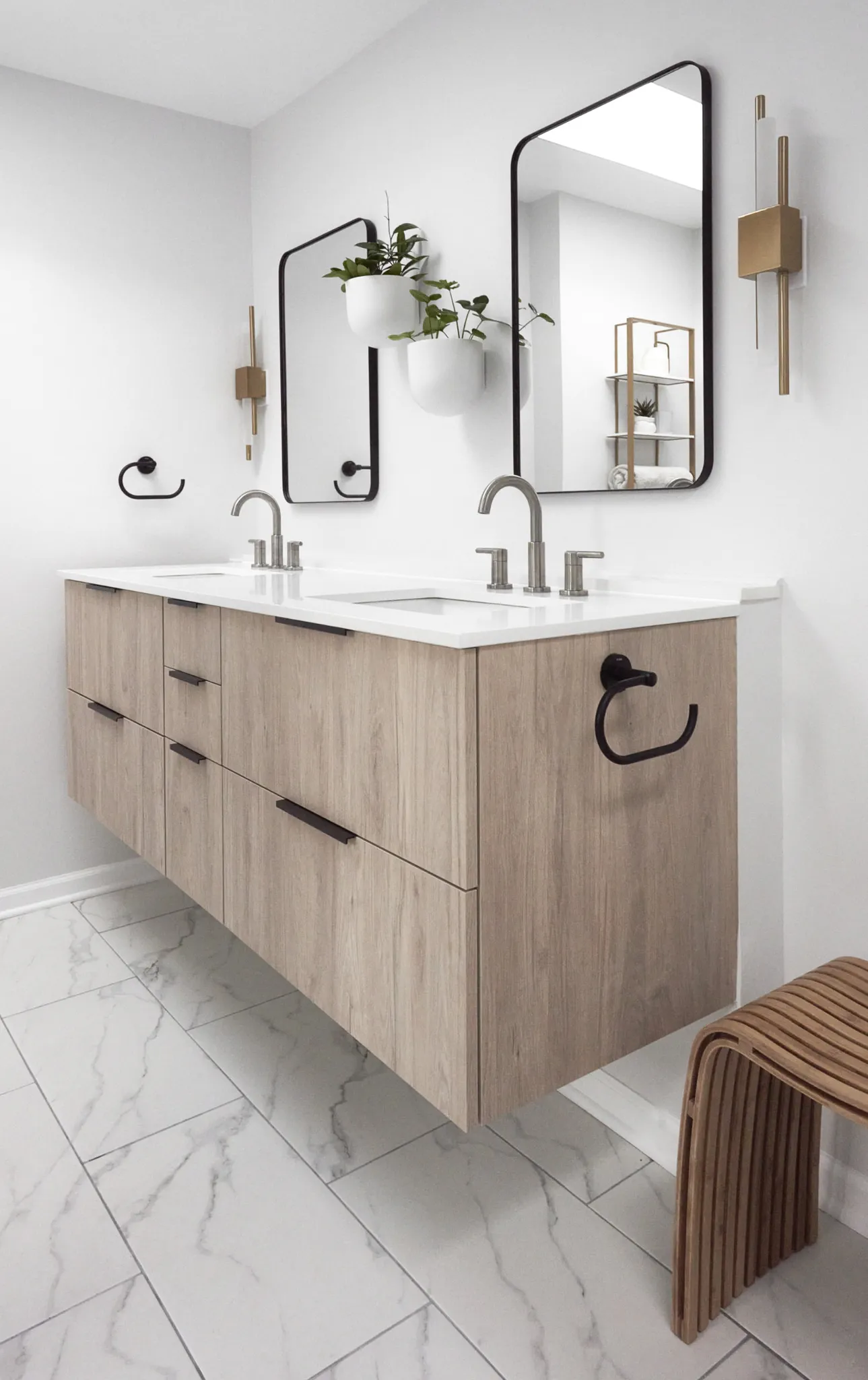 Bright bathroom with floating double sink vanity and light wood cabinets